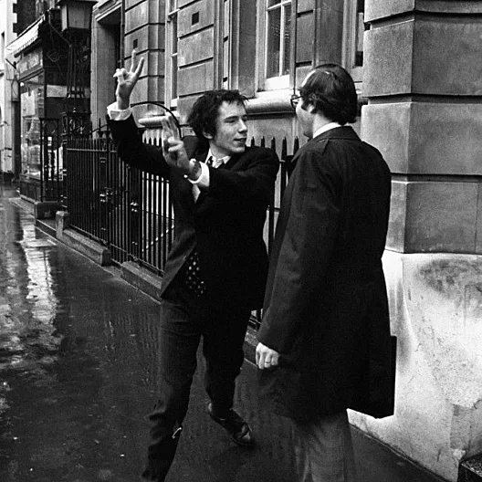 Johnny rotten lead singer with the sex pistols giving a double v sign to journalists after he had been fined 40 on a drugs charge at marlborough street magistrates court london